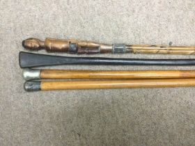 Four walking sticks including a silver topped exam