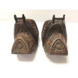 A pair of old carved possible South American stirr