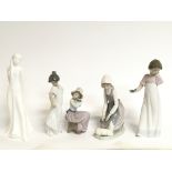 A collection of porcelain figures including Nao an
