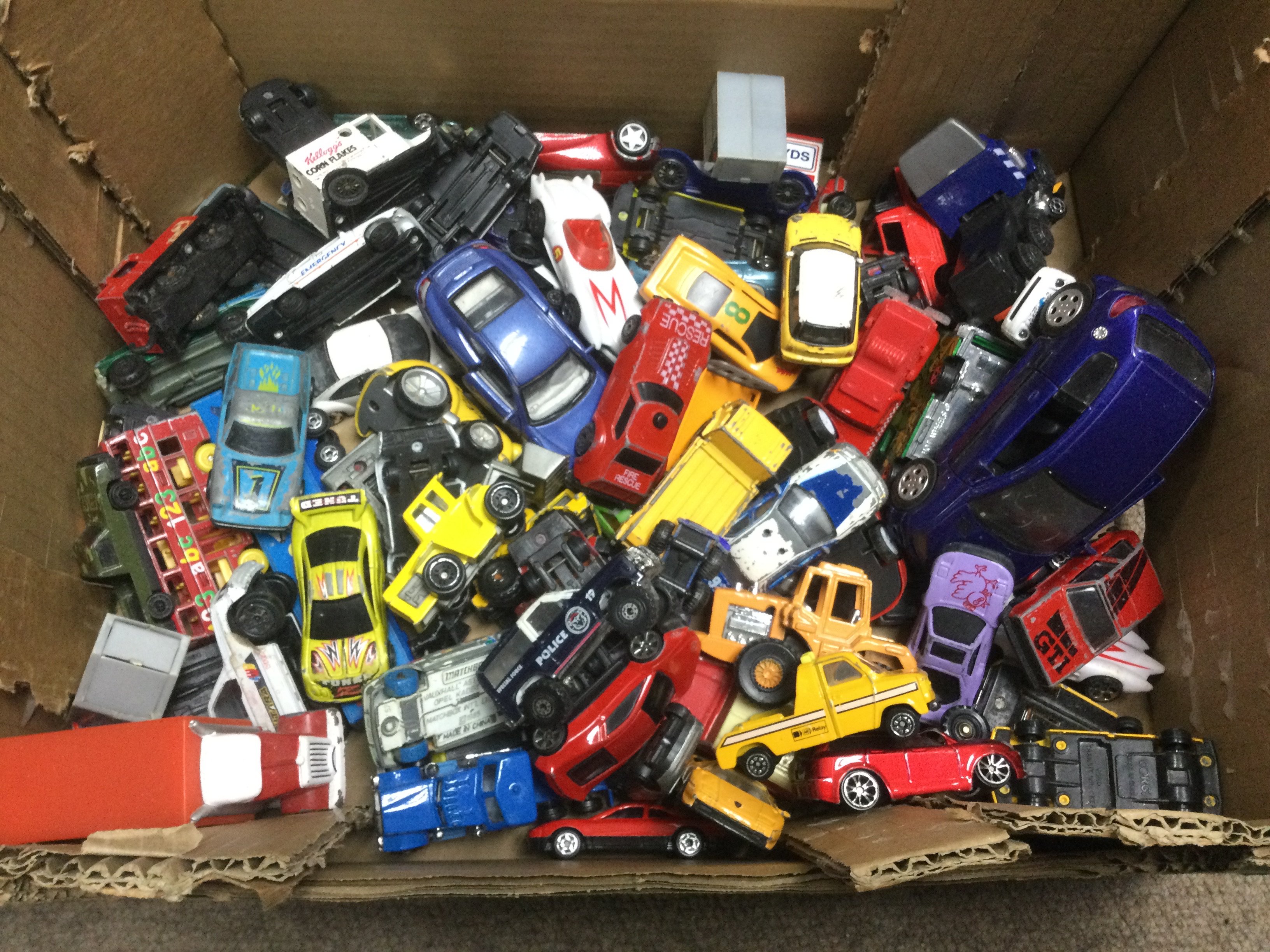 A collection of playworn die cast vehicles and a vintage packaway toy castle. Shipping category C.