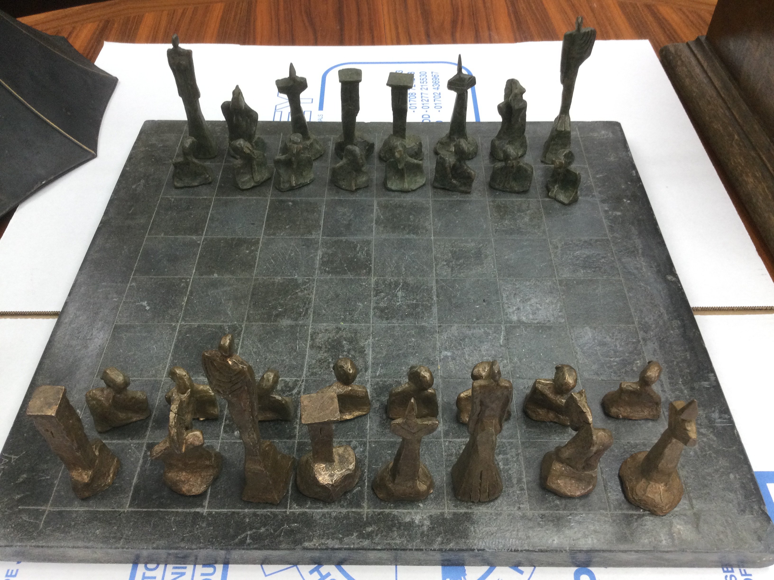 A chess set with bronzed pieces. Shipping category