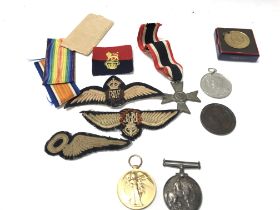 A collection of medals and badges including two wo