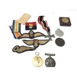 A collection of medals and badges including two wo