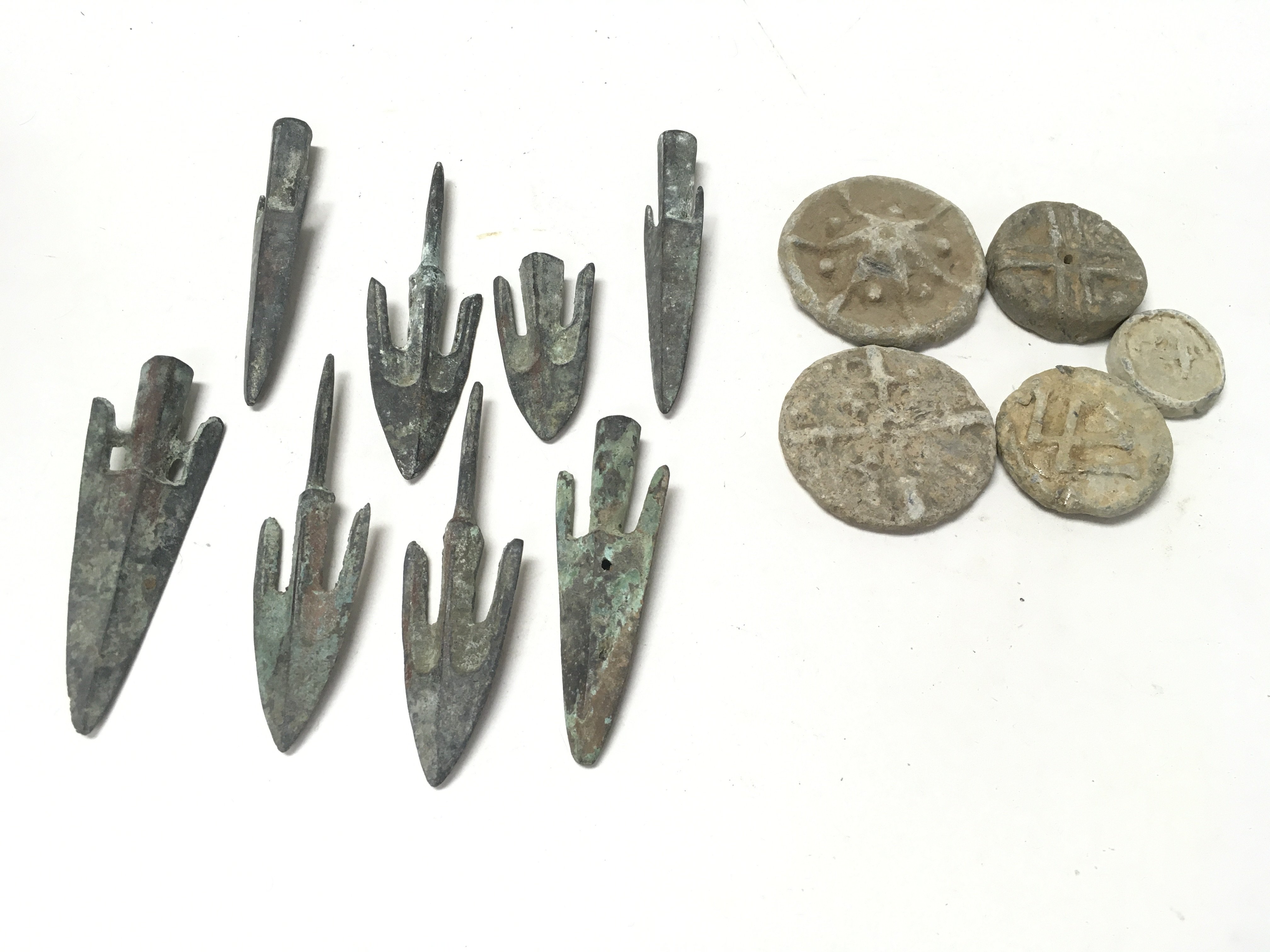 A collection of antique arrow heads and vintage to