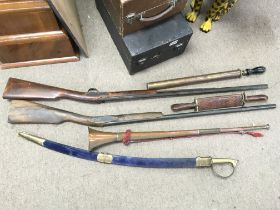 Replica muskets, an Indian curved blade sword, bugle, vintage garden sprayer