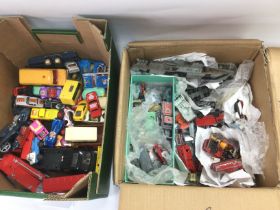 Two boxes of die cast vehicles comprising Dinky and Matchbox examples. Shipping category D.