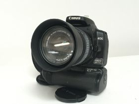 A cased Canon EOS 4D camera with Sigma telescopic
