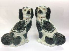 A pair of Staffordshire black and white dog orname