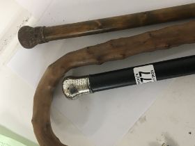 A silver topped walking stick presented by WJPalmer Lodge in 1887 and two other walking sticks. (3)