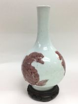A long necked baluster vase decorated with fo dogs
