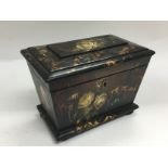 An ebonised box with hand painted giltwork and flo