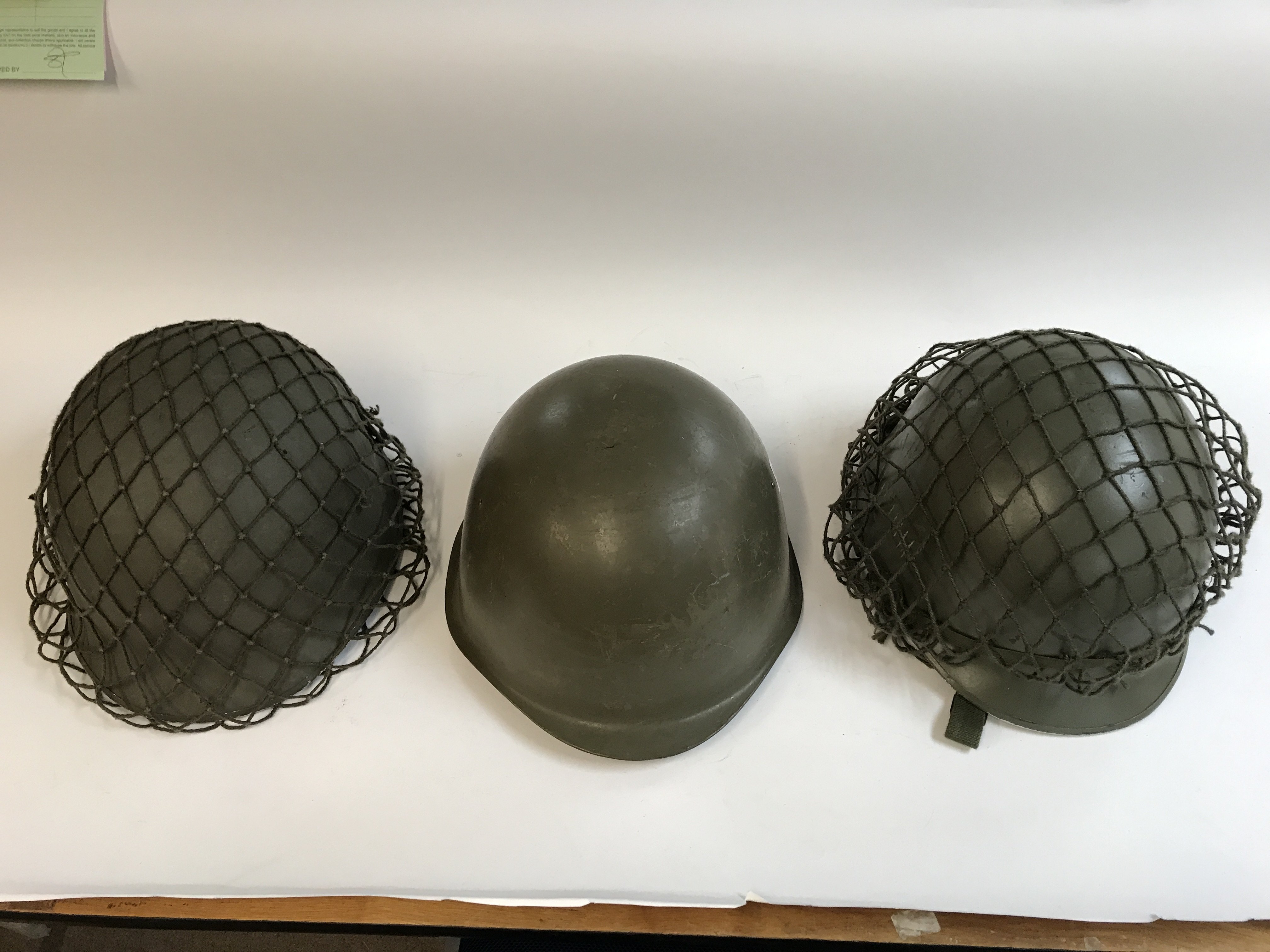 Three American military helmets with two bags a vi