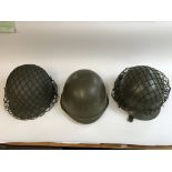 Three American military helmets with two bags a vi