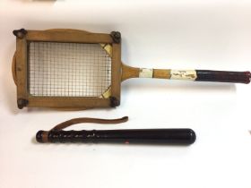 An old cricket bat along with a vintage tennis rac
