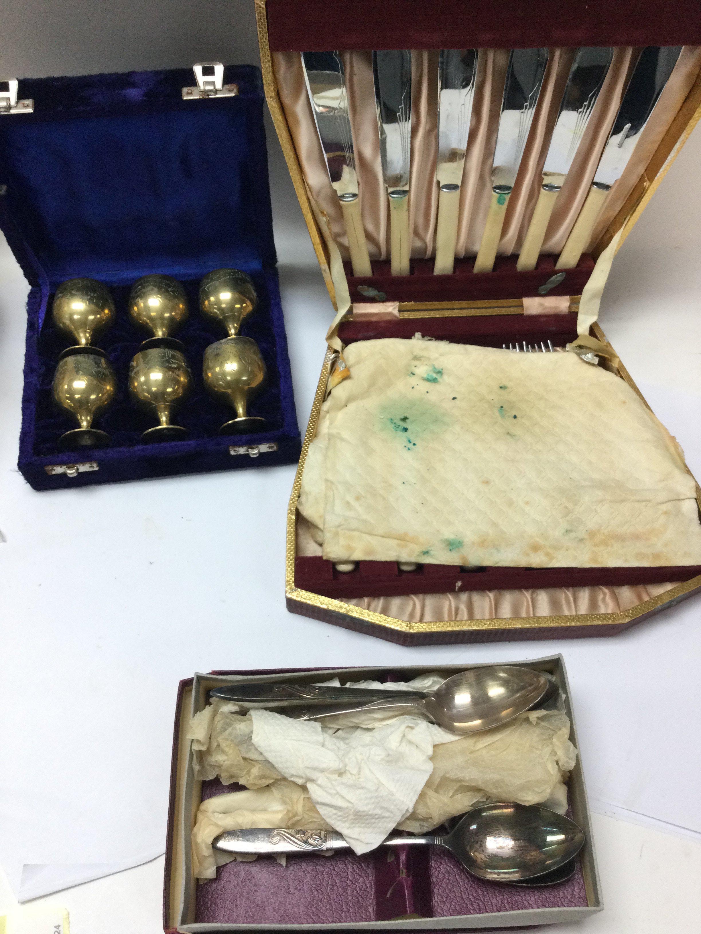 A box of silver plated cutlery and other oddments.