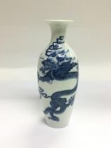 A blue and white vase decorated with a dragon and