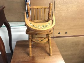 A small painted wooden dolls high chair. 49cm high