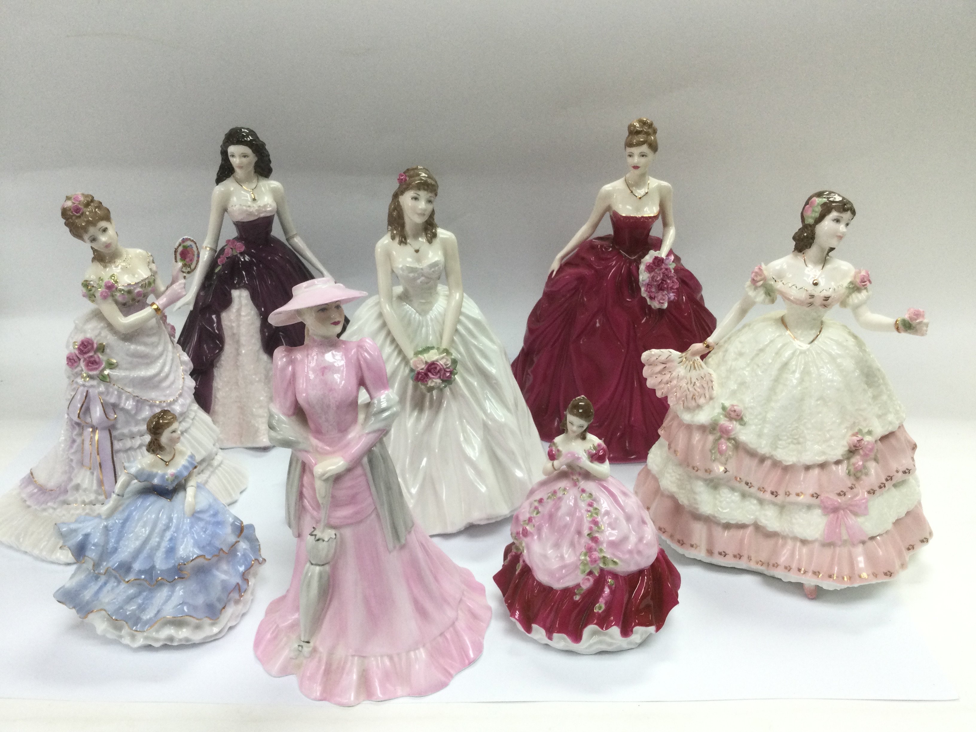 Eight ceramic figures of ladies comprising Royal W