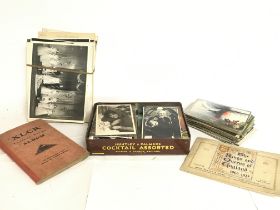 A collection of vintage postcards, cigarette cards