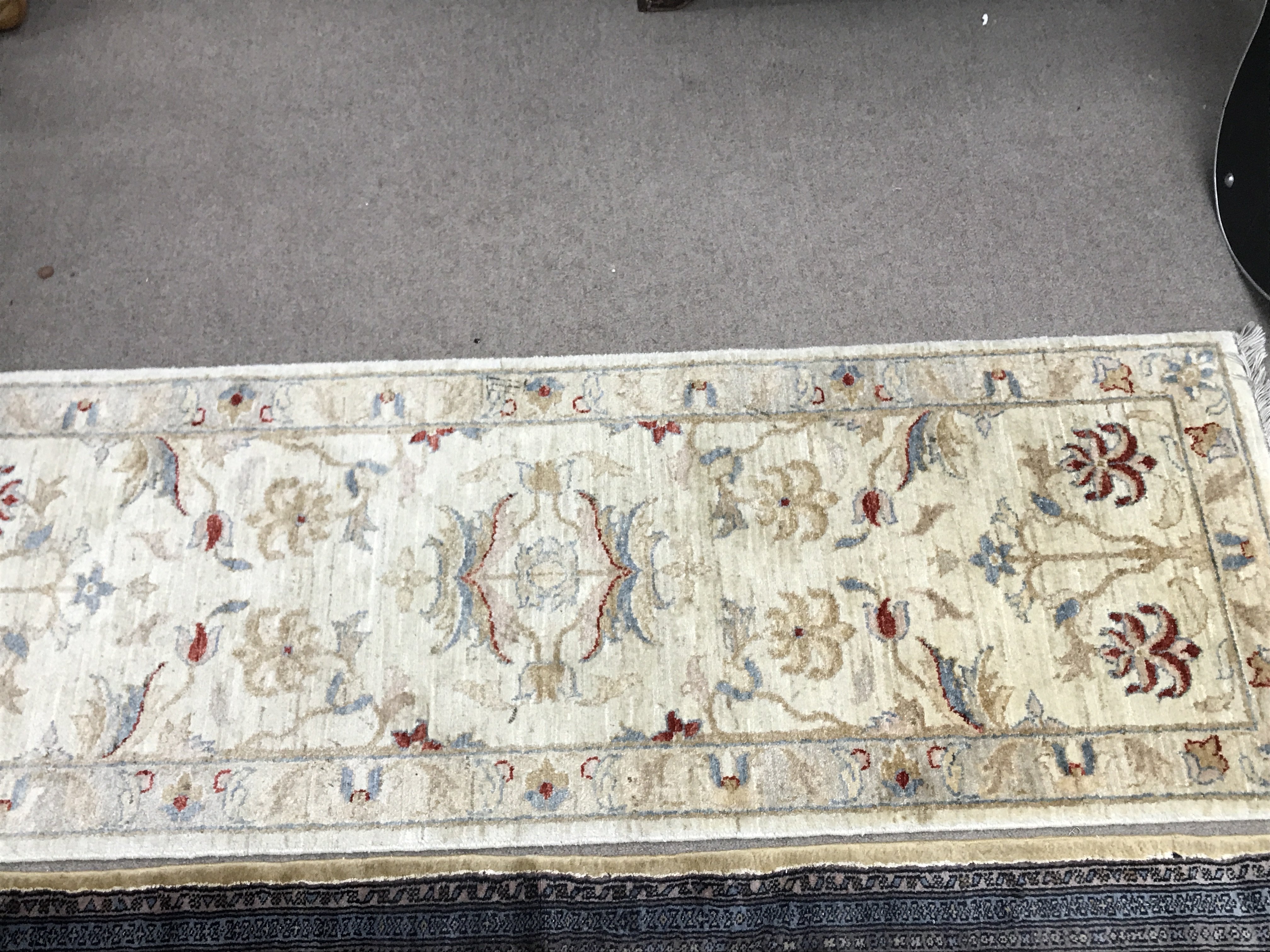 A hand tied wool hall runner rug. 182cm by 64 cm a