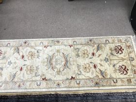 A hand tied wool hall runner rug. 182cm by 64 cm a