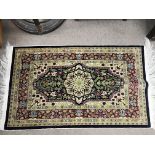 A small silk hand tied wall hanging rug. 85cm long