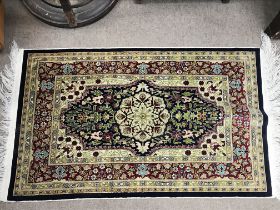 A small silk hand tied wall hanging rug. 85cm long