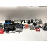 A collection of cameras and accessories including flash attachÃ© nets and lenses etc.