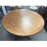 A modern teak dining table and four chairs. Table