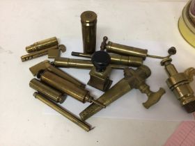 A collection of antique and brass items a lighter taps and other oddments.