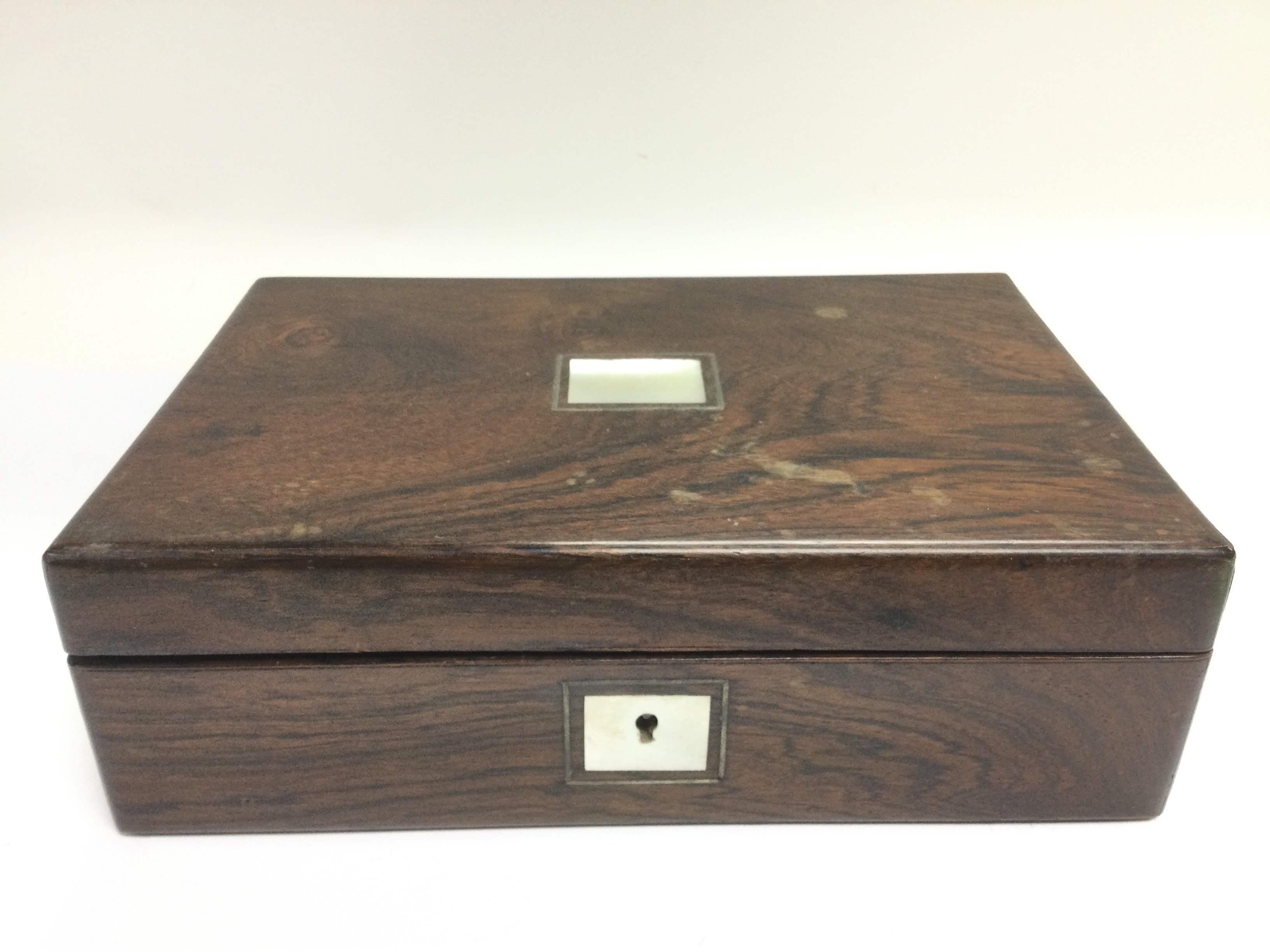A rosewood box inset with mother of pearl. Shippin