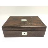 A rosewood box inset with mother of pearl. Shippin