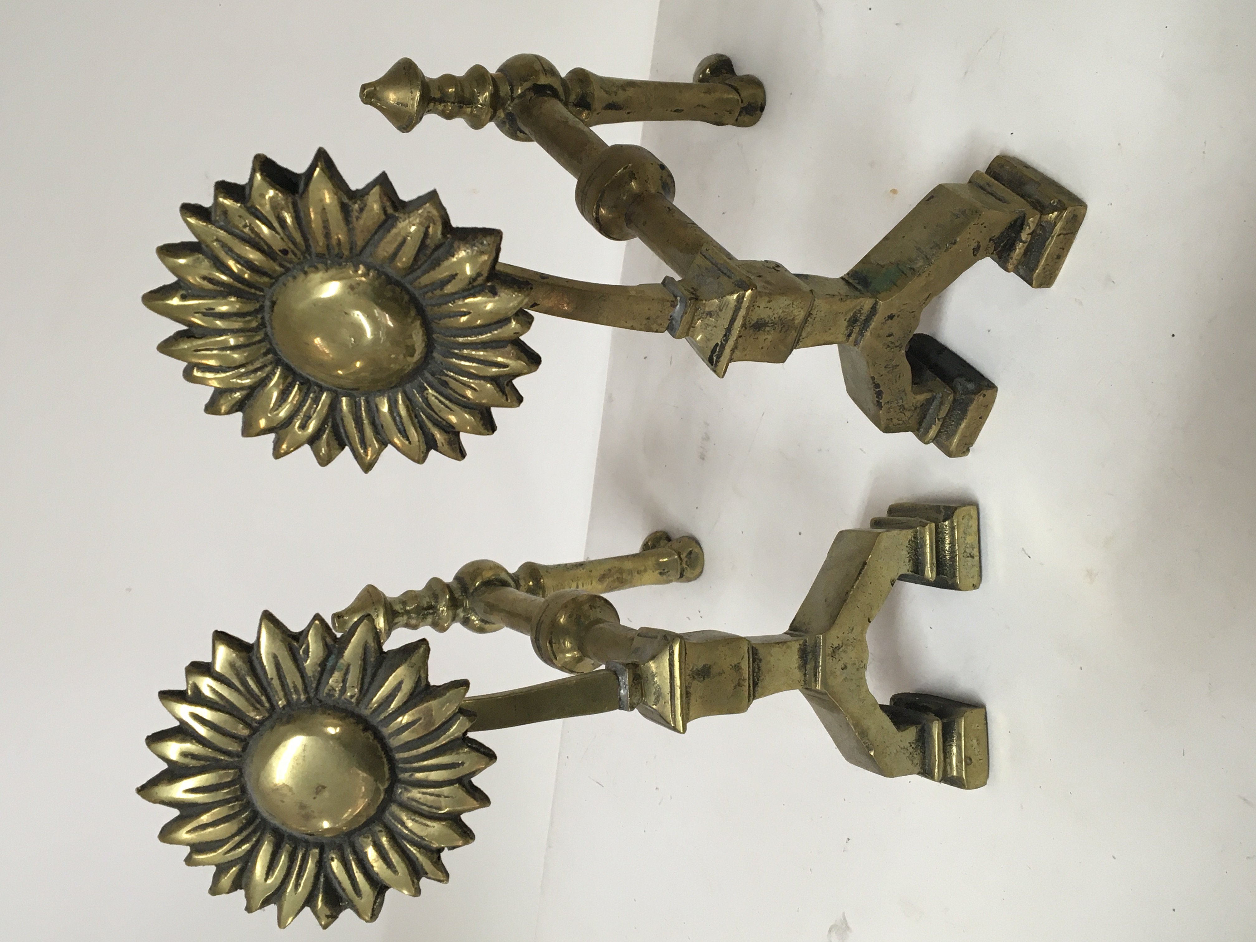 A pair of late Victorian Aesthetic brass fire side
