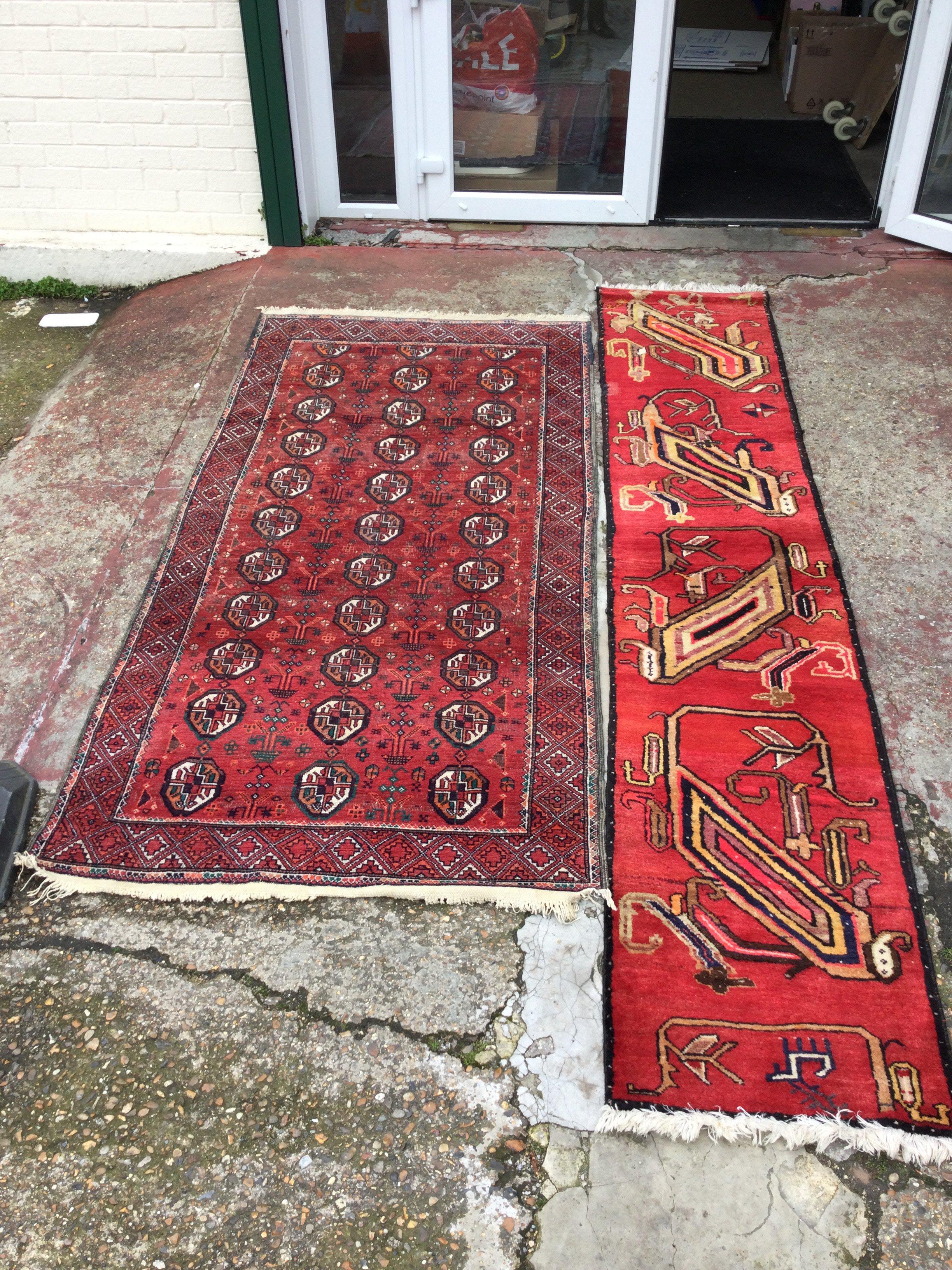 A hand knotted rug runner with an unusual pattern