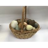 A basket of stone and marble eggs.