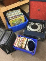 A Fidelity portable record player and a collection of LPs and 7inch singles by various artists