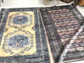 Two large 20th century hand tied wool rugs one wit