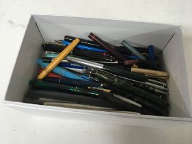 A box containing fountain pens and other pens.