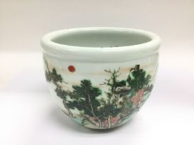 An Oriental bowl decorated with figures in a lands