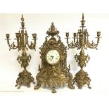 A 20th century Italian ornate bronze clock with candelabra garniture. 60 & 67cm tall. This lot