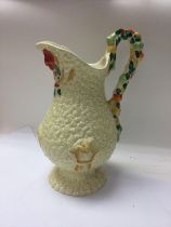A Clarice cliff jug decorated with fruits. NO RESE
