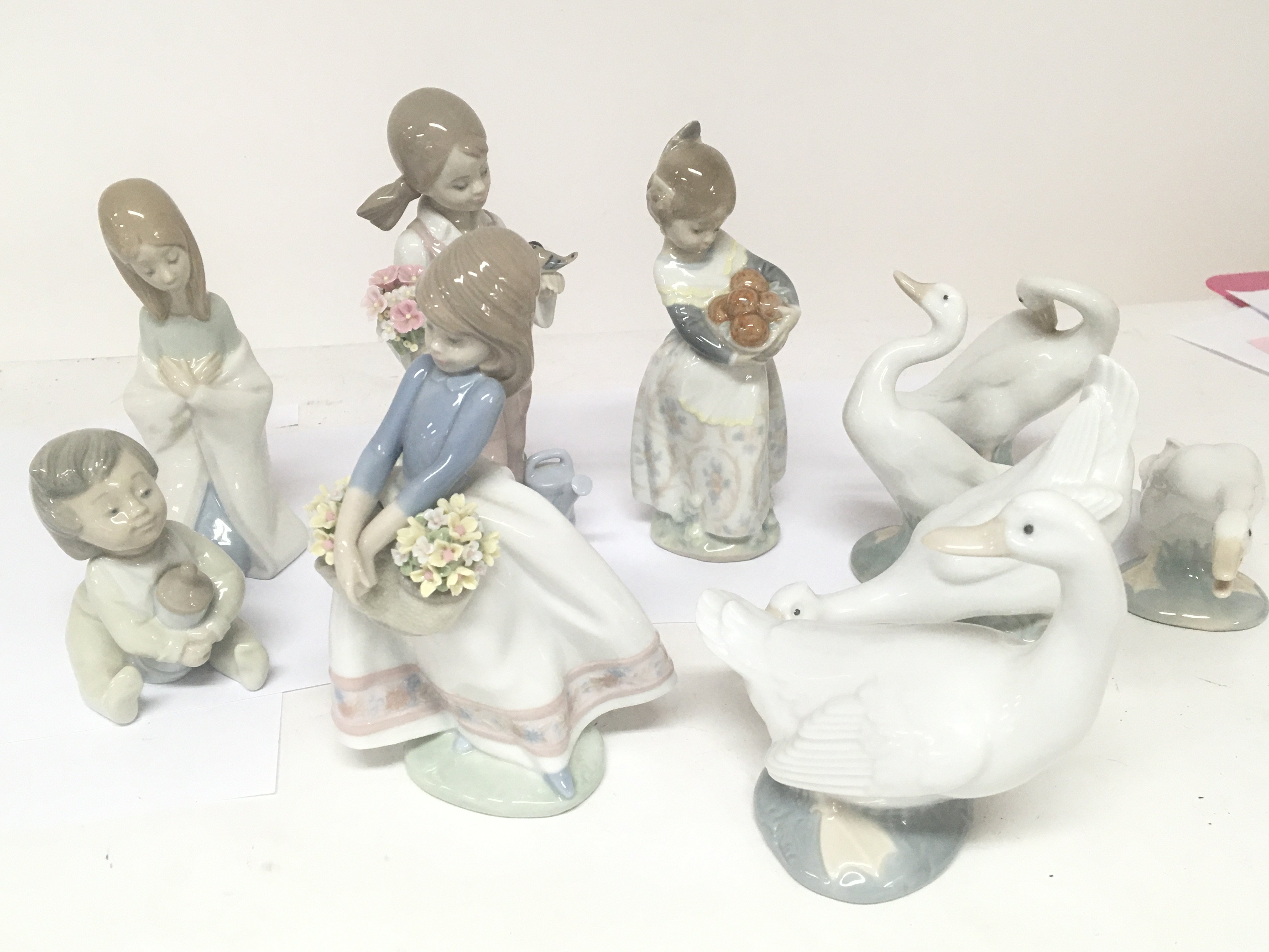 A collection of Lladro and Nao porcelain figures g