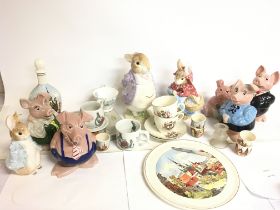 A collection of ceramics including Wade piggy banks, Enesco Peter Rabbit containers etc. This lot