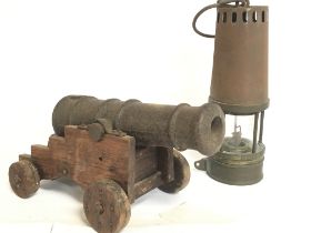 A small Cast iron cannon on a pine stand and a Ric