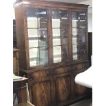 A mahogany reproduction display cabinet with glass