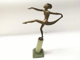 An Art Deco style figurine on a stone base. Base h