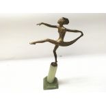 An Art Deco style figurine on a stone base. Base h