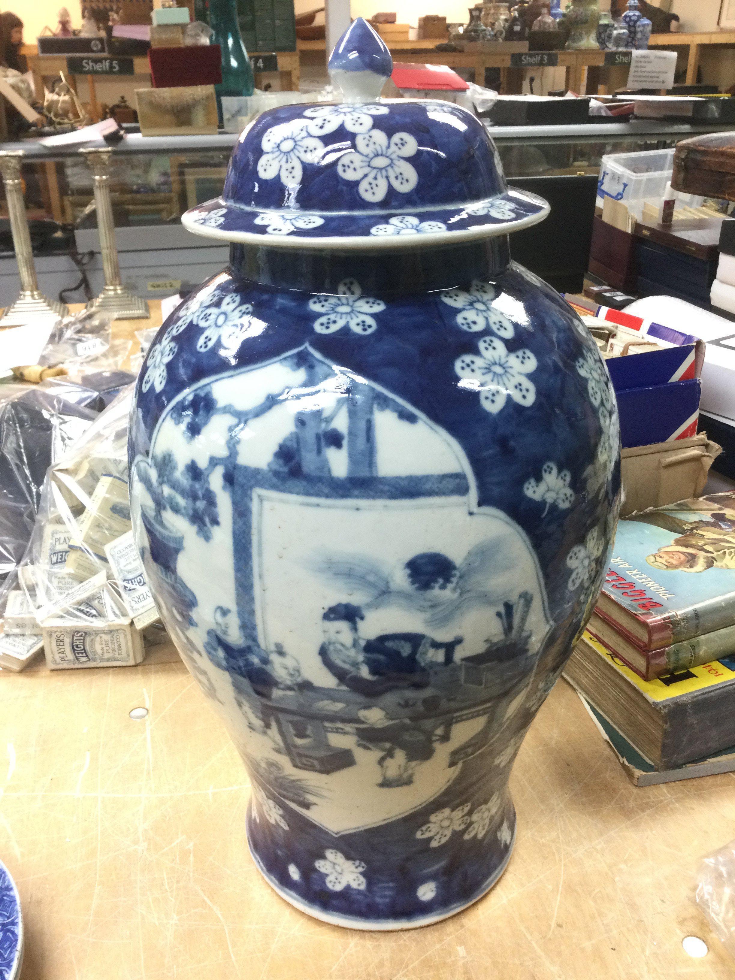 A large blue and white vase and cover decorated wi