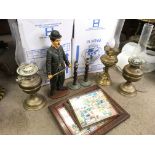 A collection of items including oil lamps with shades, twist candlesticks and a Charlie Chaplin