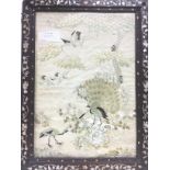 A framed and glazed silk embroidery of peacocks an